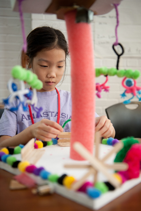 Young girl creating a model